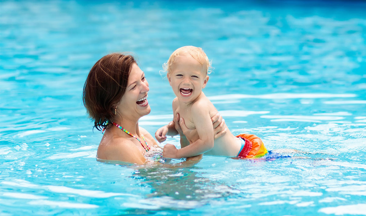happy woman and kid in pool