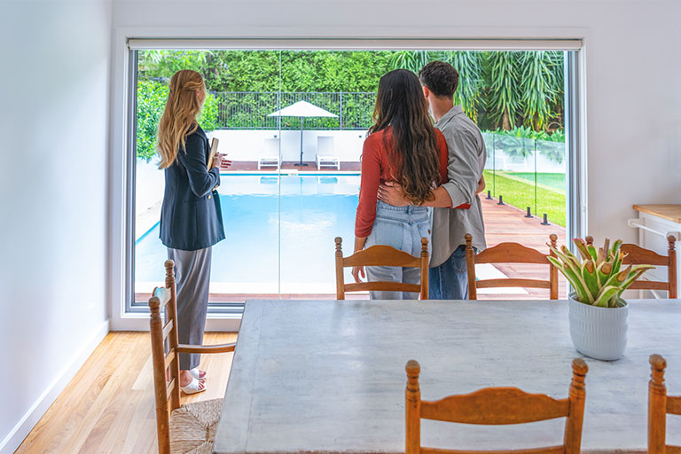 Persons looking at pool through the whindow